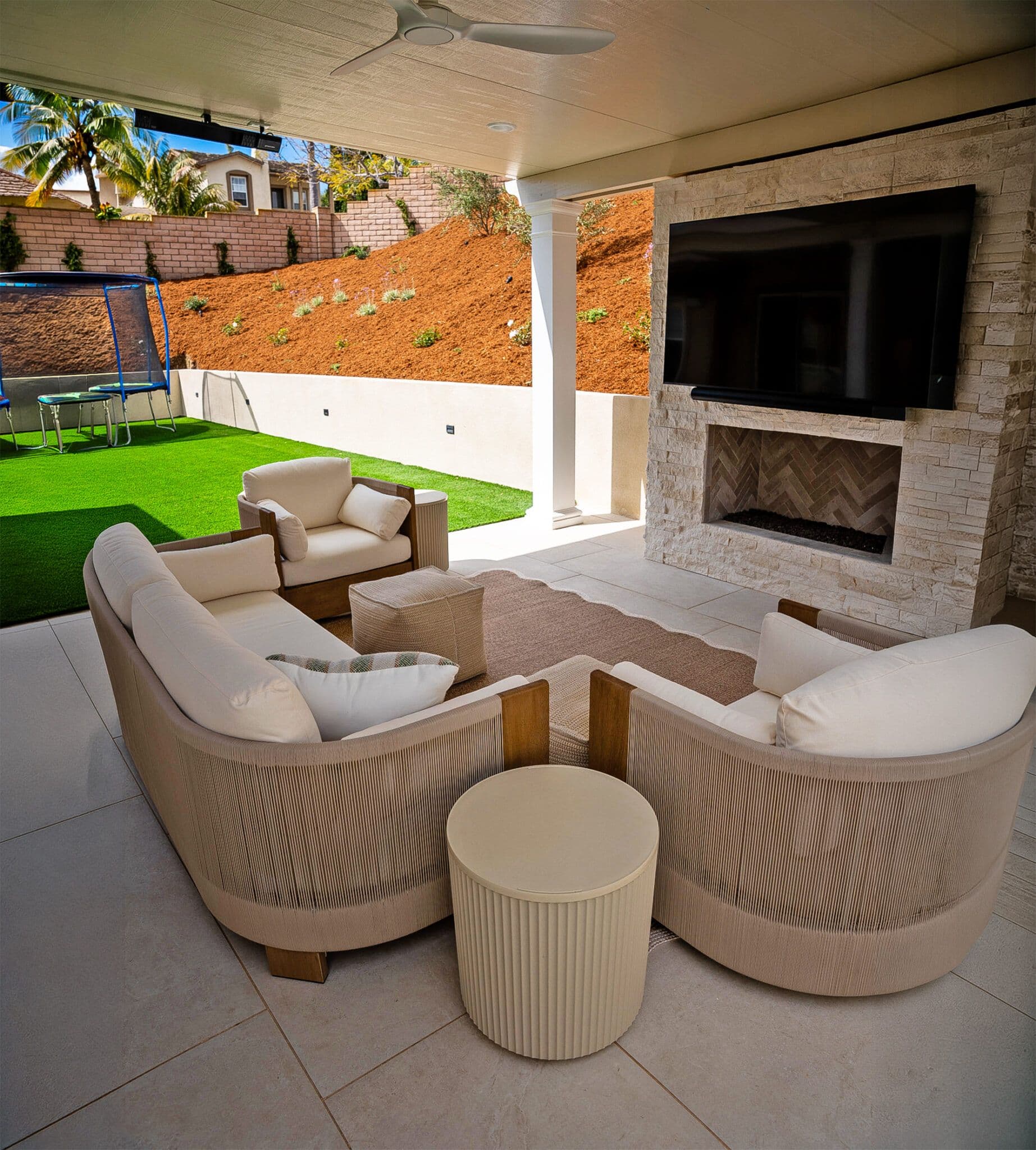 Outdoor patio remodel with fireplace and turf