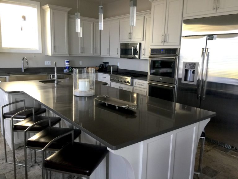 White cabinets and black counters in a newly renovated kitchen
