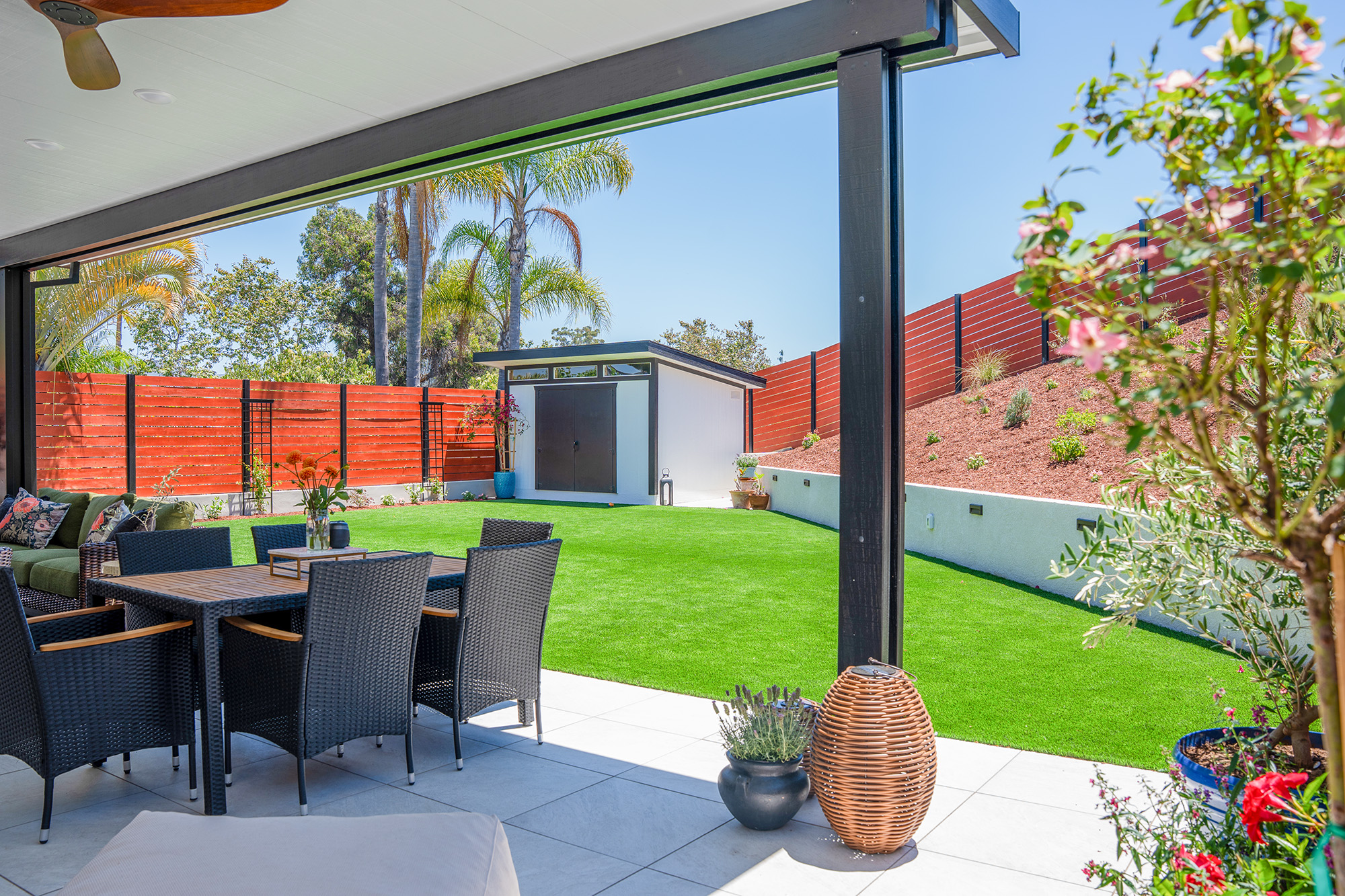 Backyard remodel with artificial turf, retaining wall and landscaping